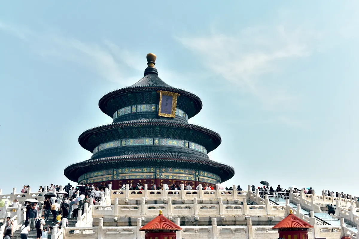 Tourists gather at the iconic Temple of Heaven on a sunny day in Beijing, China.